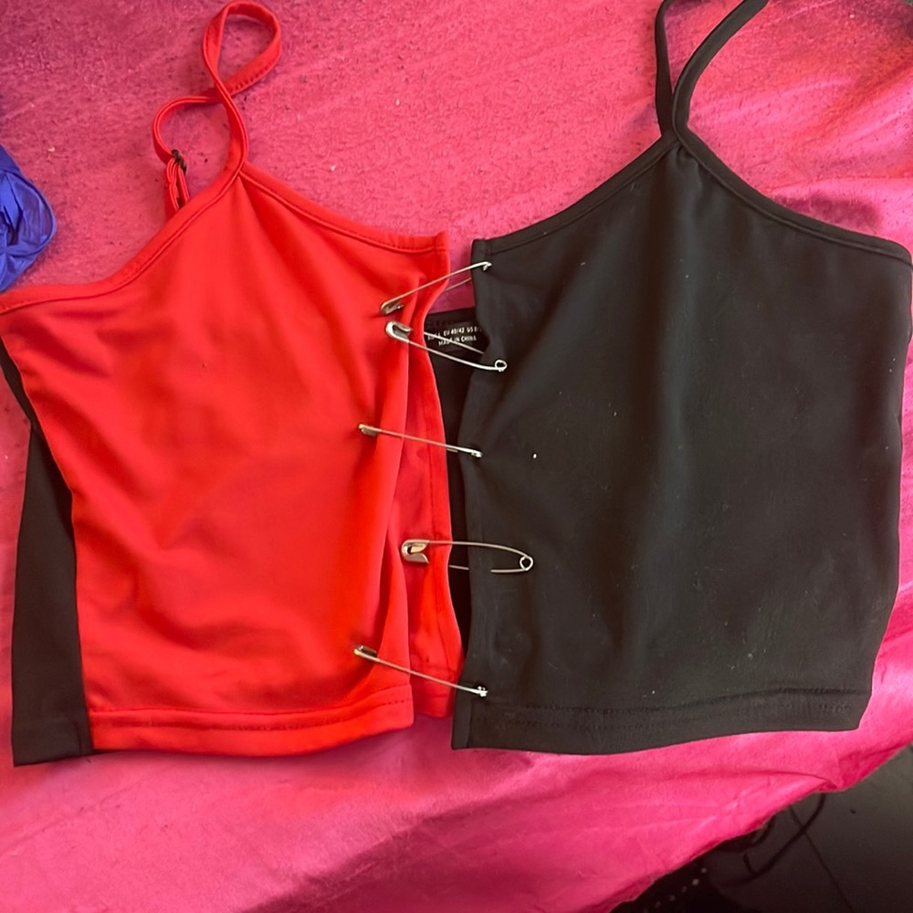 this is a red and black crop top held together by safety pins in the front :)